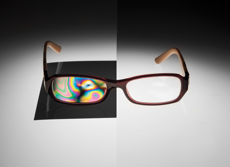 Figure 12: A pair of glasses appears clear without polarization; however, the use of polarizers makes visible the material stress variations and they appear as color variations.</h5>
